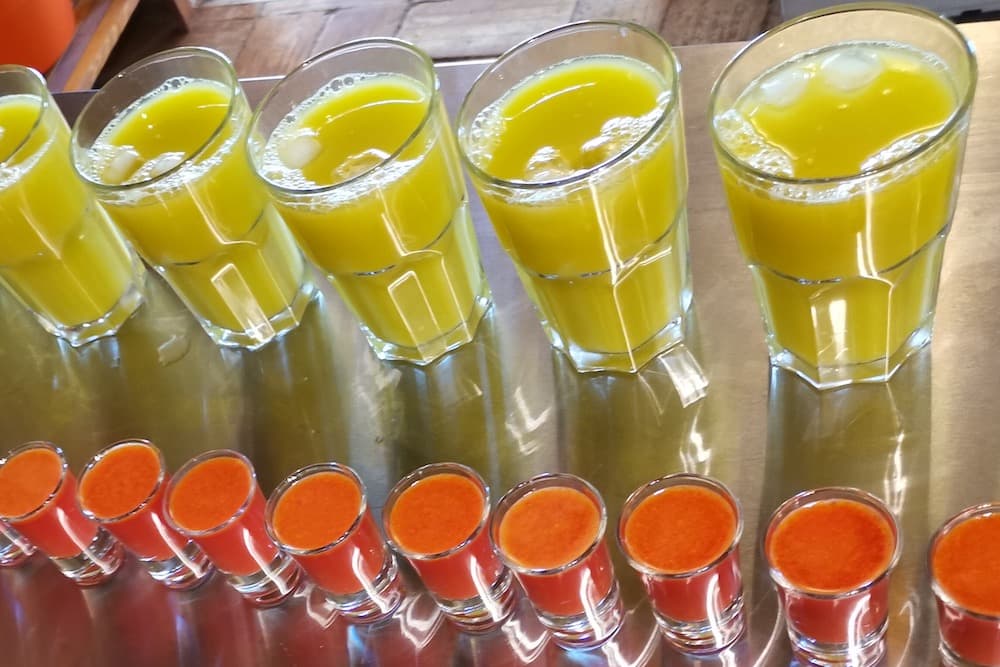 Freshly pressed juices lined up in the juice kitchen