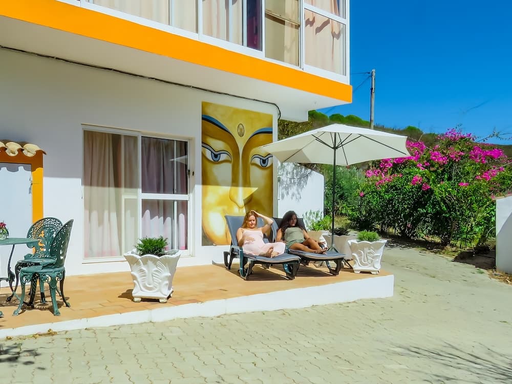 Guests relaxing on a sunny terrace at Moinhos Velhos