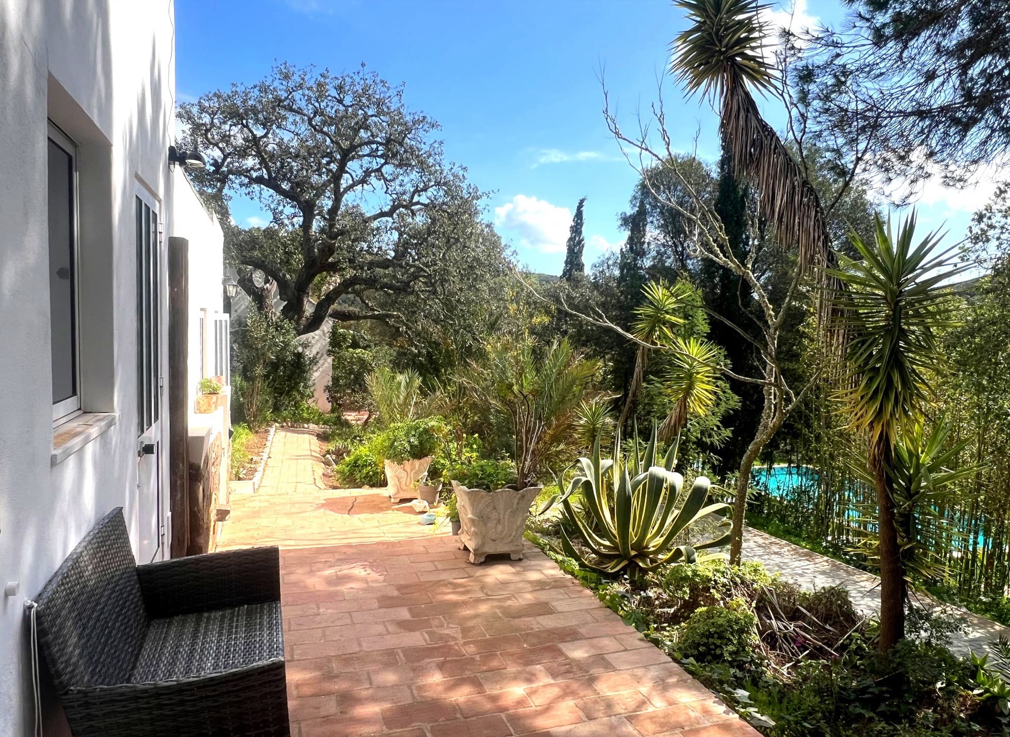 Garden path through the grounds at Moinhos Velhos, pool visible below